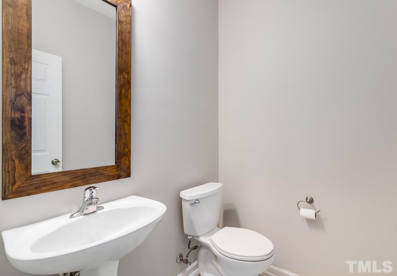 8 Sharpstone Lane Durham, NC 27703 - Photo 8 of 15 a bathroom with a sink a toilet and mirror