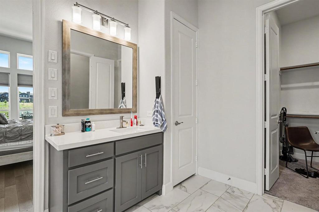 573 Broadleaf Way Haslet, TX 76052 - Photo 24 of 35 a bathroom with a double vanity sink and mirror