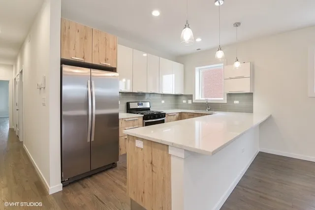 a kitchen with kitchen island granite countertop cabinets and stainless steel appliances