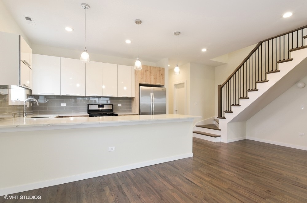 3326 West Irving Park Road, Unit 3W Chicago, IL 60618 - Photo 4 of 15 a view of kitchen with stainless steel appliances refrigerator oven and cabinets