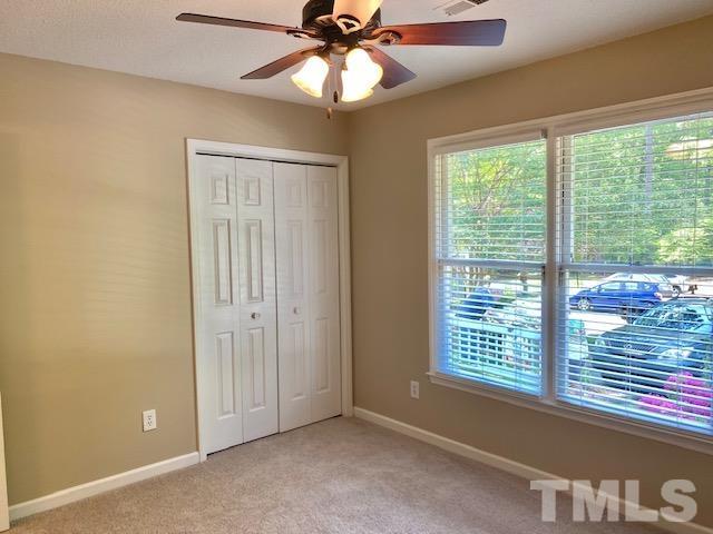 6412 Meadow View Drive Raleigh, NC 27609 - Photo 11 of 13 an empty room with windows and fan