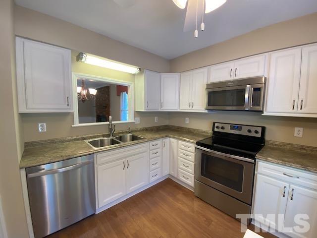6412 Meadow View Drive Raleigh, NC 27609 - Photo 2 of 13 a kitchen with a sink stove and microwave