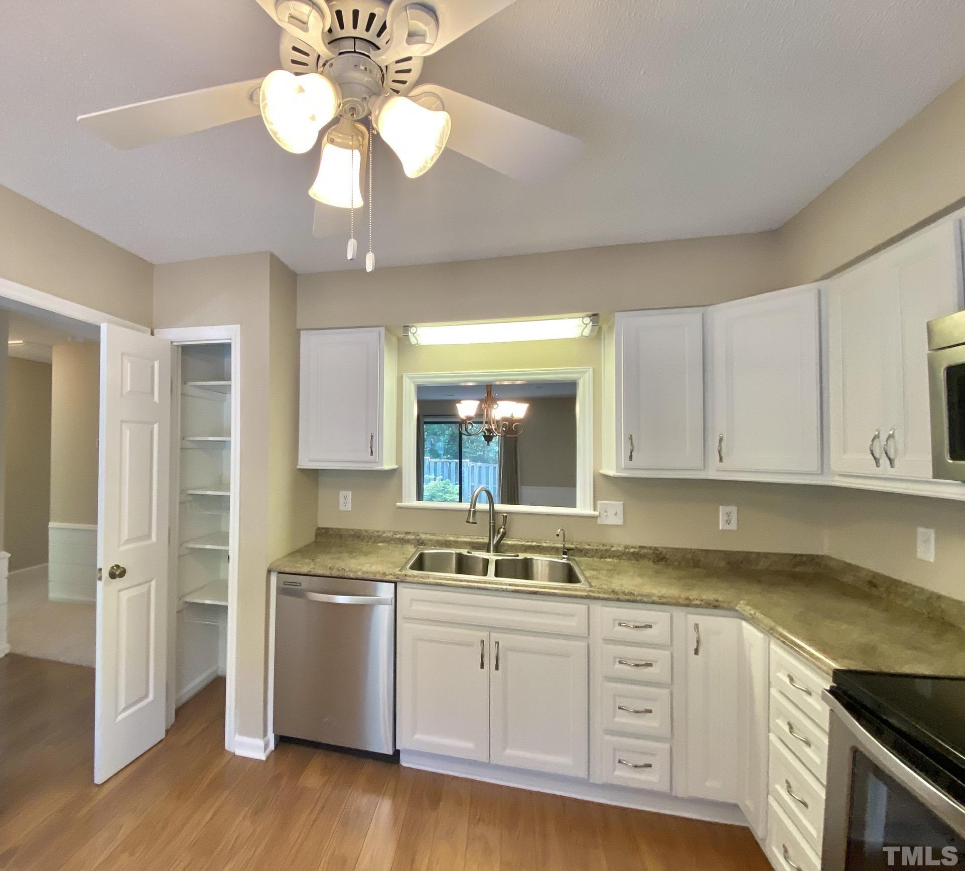 6412 Meadow View Drive Raleigh, NC 27609 - Photo 3 of 13 a kitchen with granite countertop a sink stainless steel appliances and cabinets