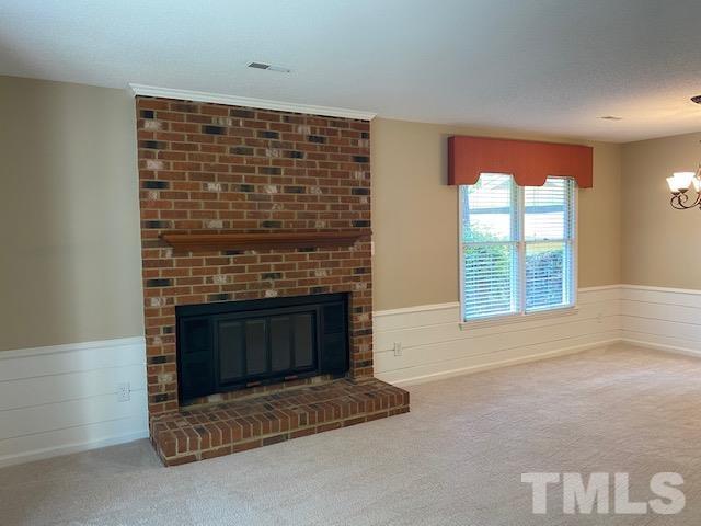 6412 Meadow View Drive Raleigh, NC 27609 - Photo 6 of 13 a living room with furniture a fireplace and a large window
