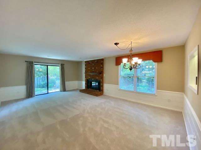 6412 Meadow View Drive Raleigh, NC 27609 - Photo 7 of 13 a view of an empty room with a fireplace and a window