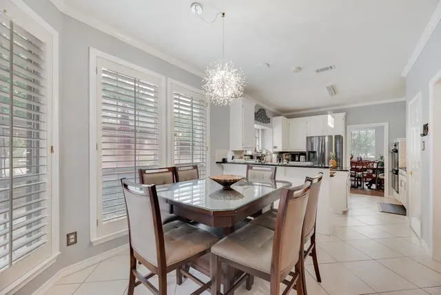 a view of a dining room with furniture and chandelier