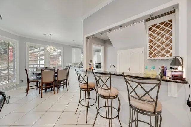 a large white kitchen with a large counter top appliances and cabinets