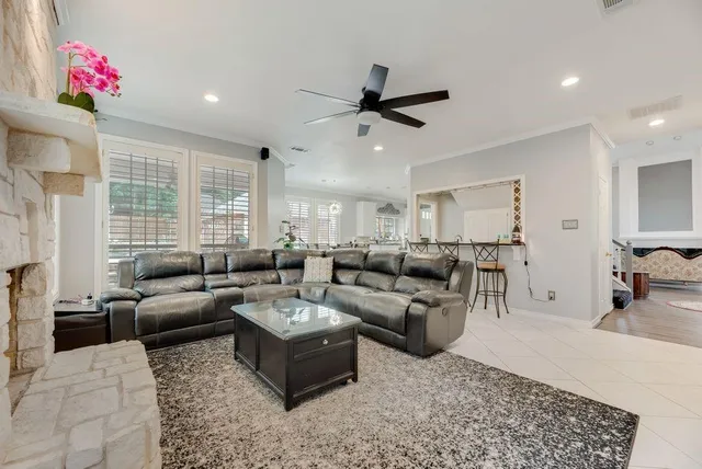a living room with furniture a flat screen tv and a fireplace