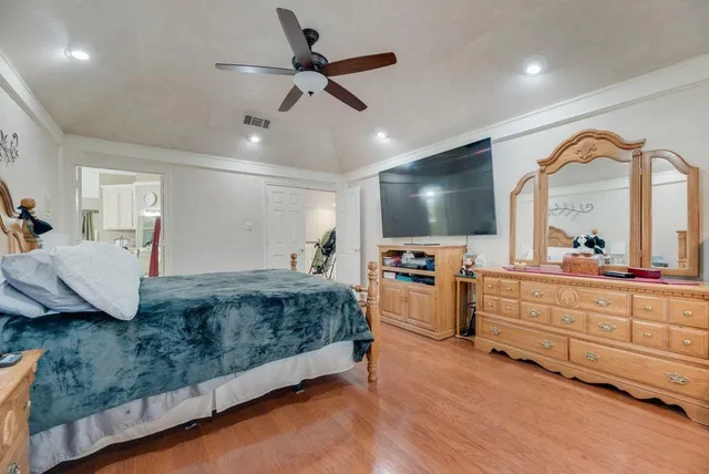 a spacious bedroom with a bed and a chandelier