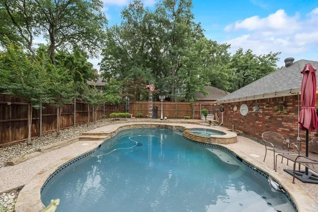 a patio with hardwood table and chairs