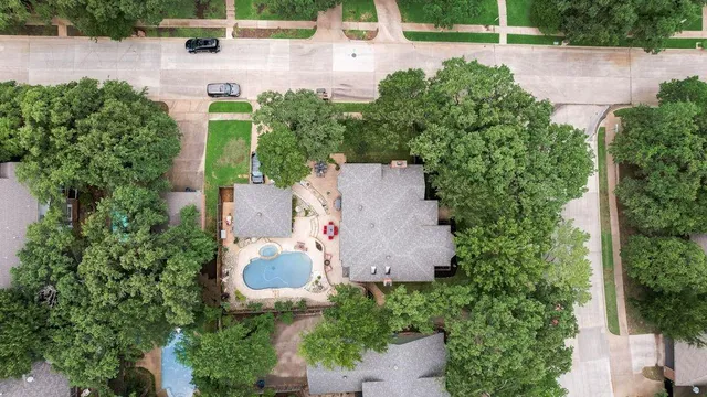an aerial view of a house with a yard and outdoor seating