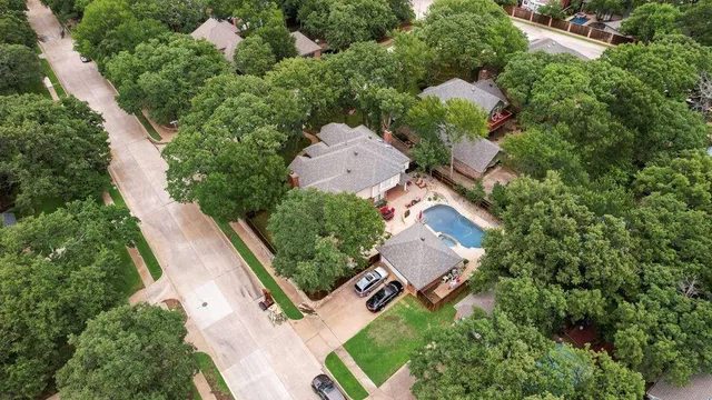 an aerial view of a house with a yard