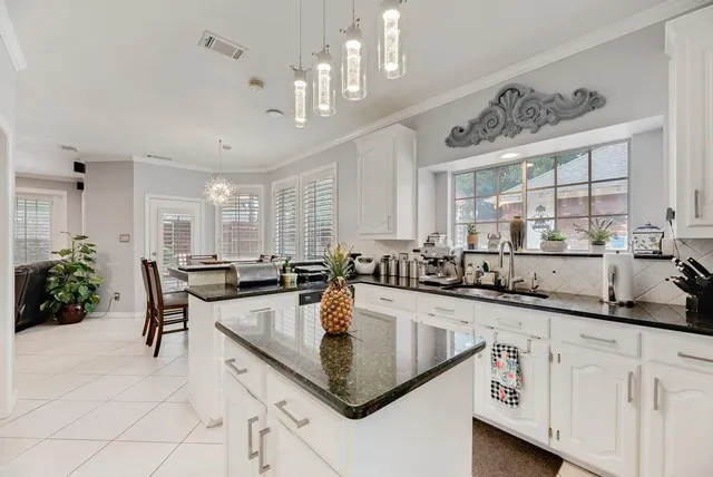 a kitchen with stainless steel appliances granite countertop a sink refrigerator and microwave