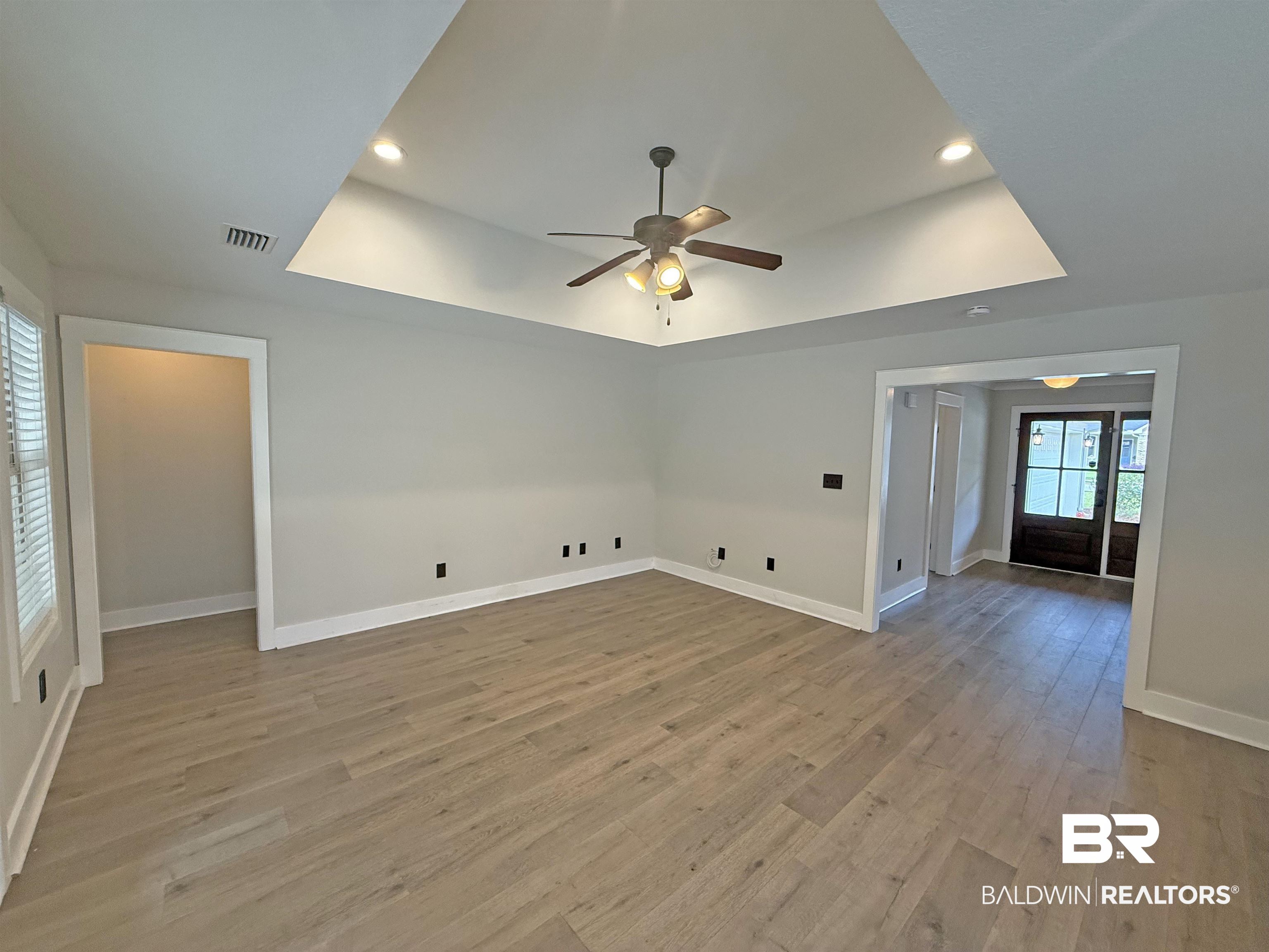 22023 Garland Loop Silverhill, AL 36576 - Photo 5 of 33 Empty room with a raised ceiling, a ceiling fan, light wood-style flooring, and recessed lighting