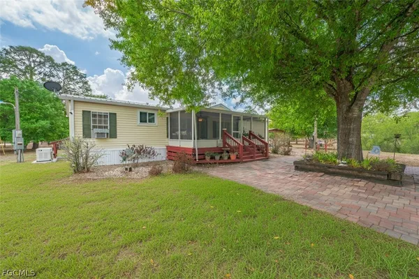a view of a house with backyard sitting area and garden