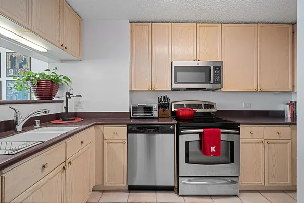 a kitchen with granite countertop a stove and a sink