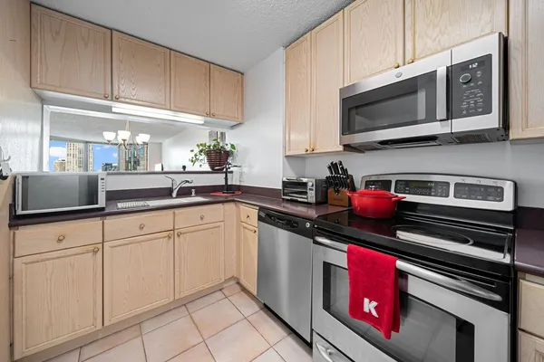 a kitchen with stainless steel appliances granite countertop a stove a microwave and cabinets