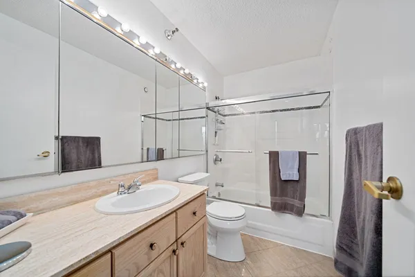 a bathroom with a sink toilet and shower
