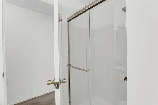 a bathroom with a glass shower door