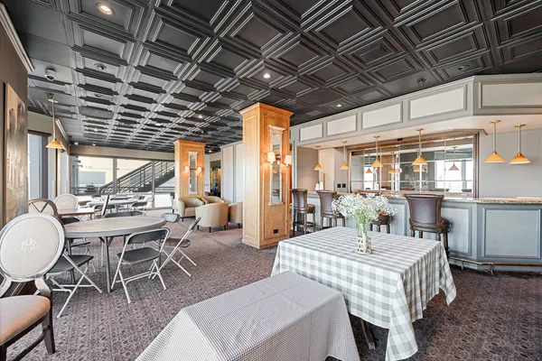 a dining room with furniture a chandelier and a rug