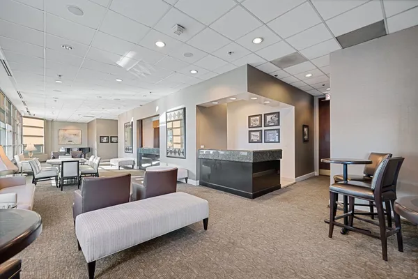 a living room with furniture and a kitchen