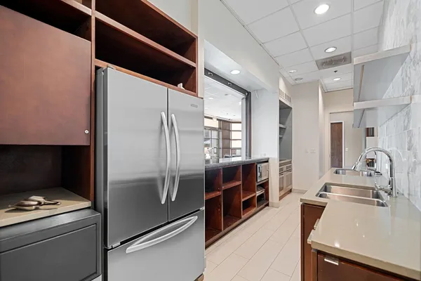 a kitchen with kitchen island a counter appliances a sink and cabinets