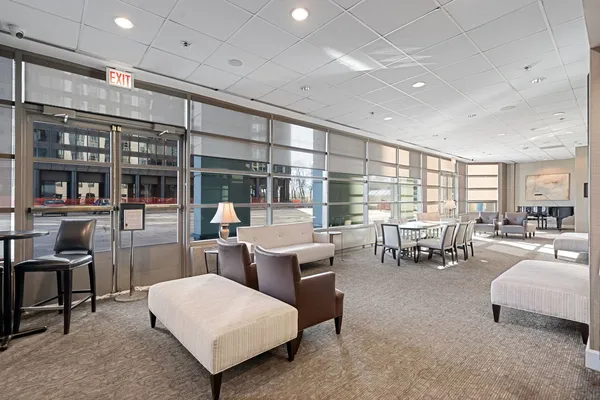 a living room with furniture and large window