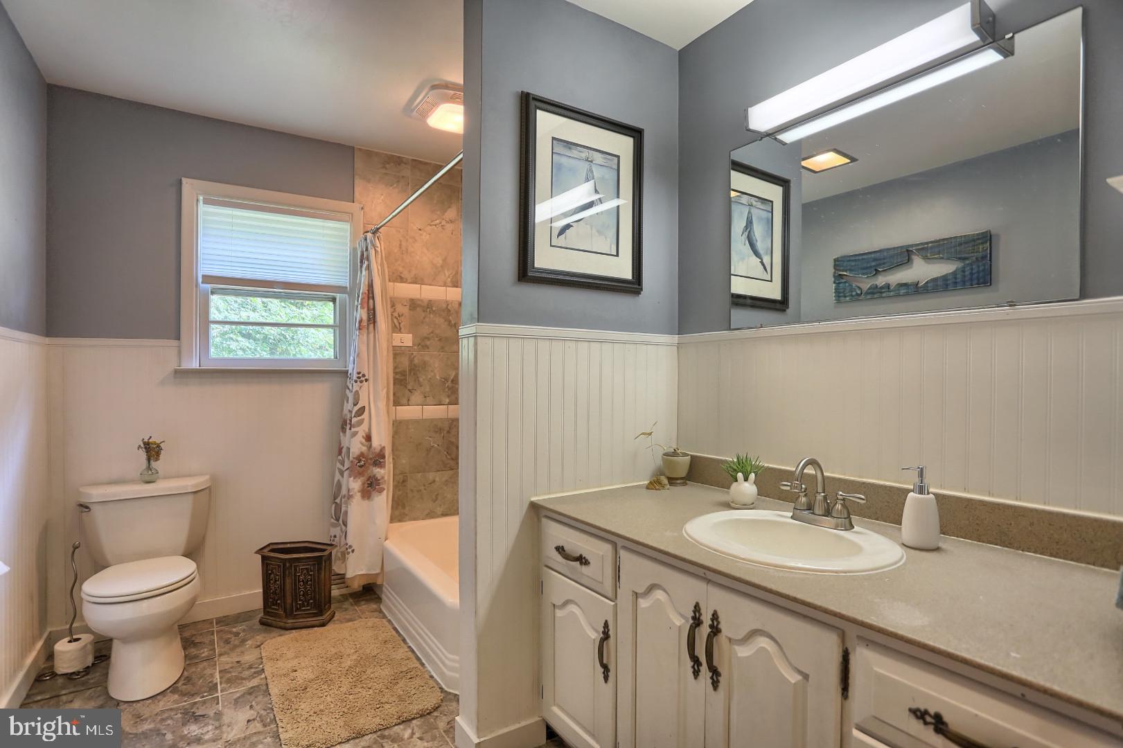 2345 River Road Reading, PA 19605 - Photo 7 of 28 a bathroom with a granite countertop sink toilet and a mirror