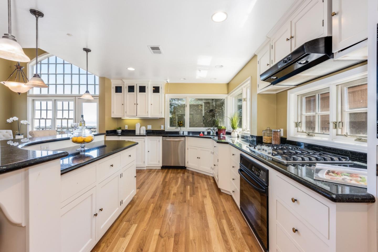 24 Shratton Avenue San Carlos, CA 94070 - Photo 11 of 13 a kitchen with stainless steel appliances a sink stove and cabinets