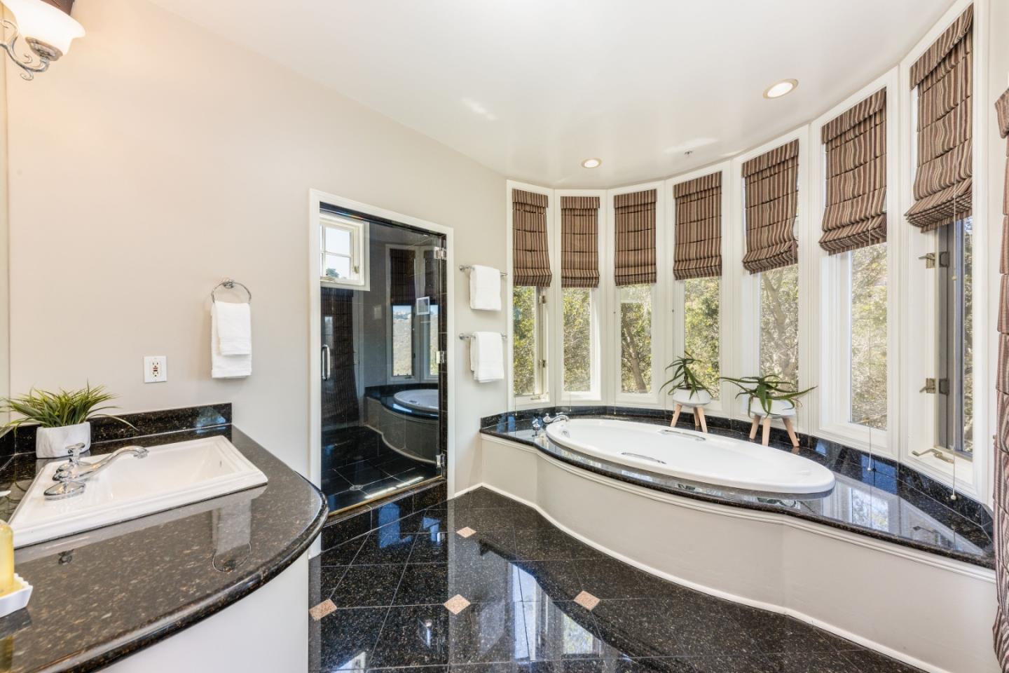 24 Shratton Avenue San Carlos, CA 94070 - Photo 9 of 13 a spacious bathroom with a granite countertop sink and a large mirror