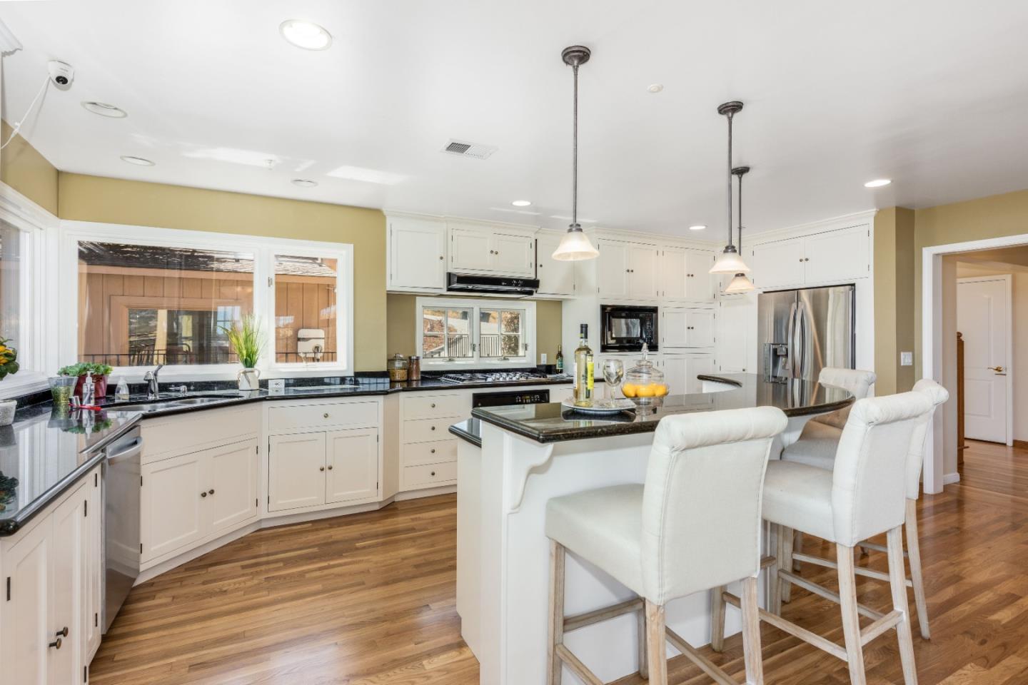 24 Shratton Avenue San Carlos, CA 94070 - Photo 10 of 13 a kitchen with stainless steel appliances kitchen island granite countertop a stove a sink and a refrigerator