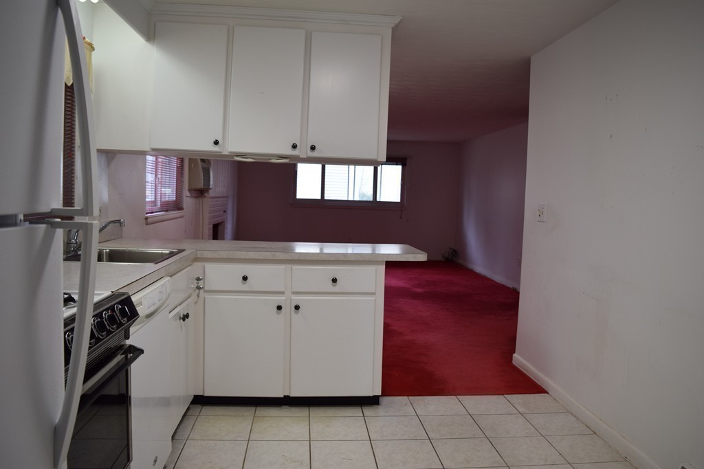 2 Russell Road Wayland, MA 01778 - Photo 3 of 13 a kitchen with a refrigerator stove and cabinets
