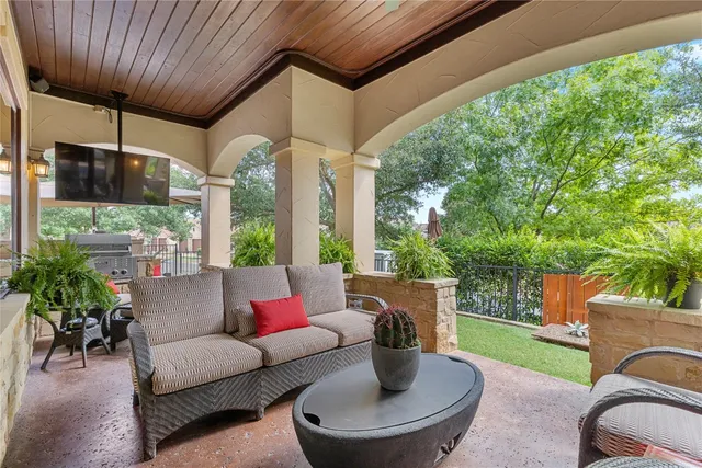 a outdoor living space with furniture potted plant and a large window