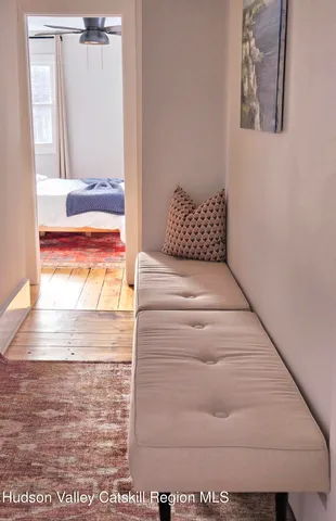 a bedroom with a bed dresser and window