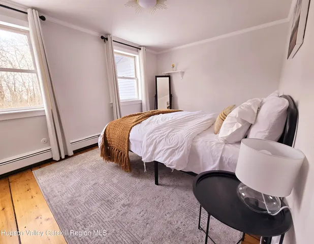 a bathroom with a toilet sink a mirror and window