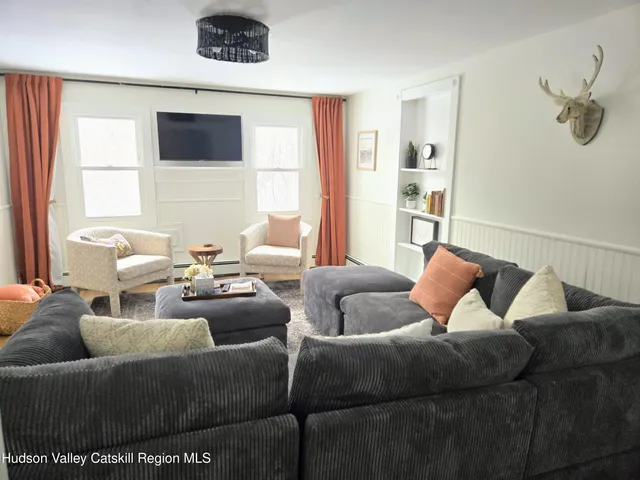 a living room with furniture and a wooden floor