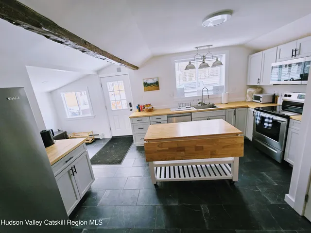 a very nice looking dining room with wooden floor and furniture