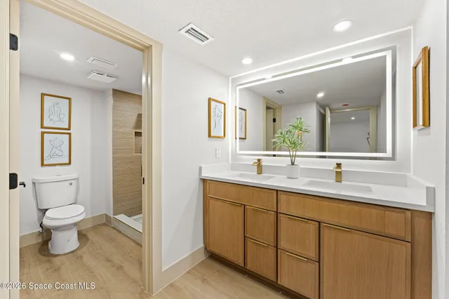 a bathroom with a toilet sink and a mirror