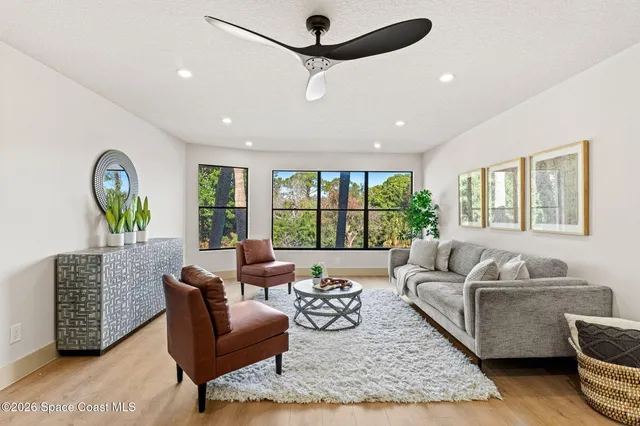 a living room with furniture and a large window