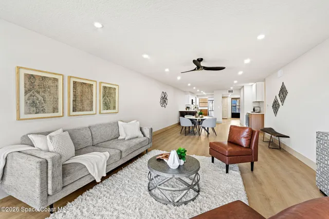 a living room with furniture and kitchen view
