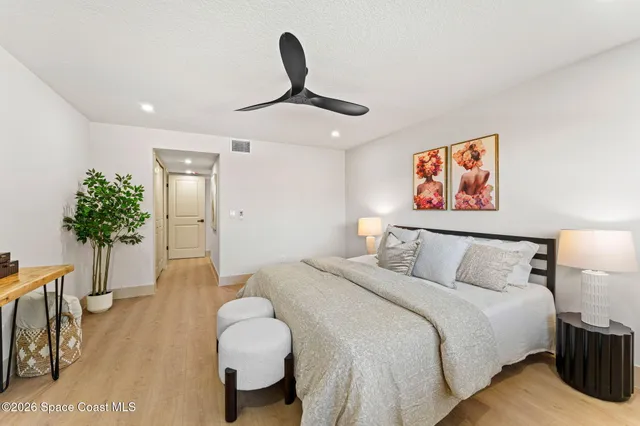 a bedroom with a bed and a painting on the wall