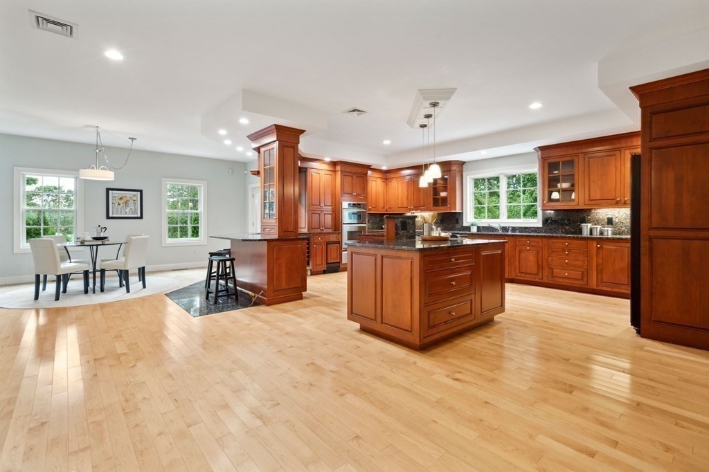 a kitchen with stainless steel appliances granite countertop a refrigerator and a stove top oven