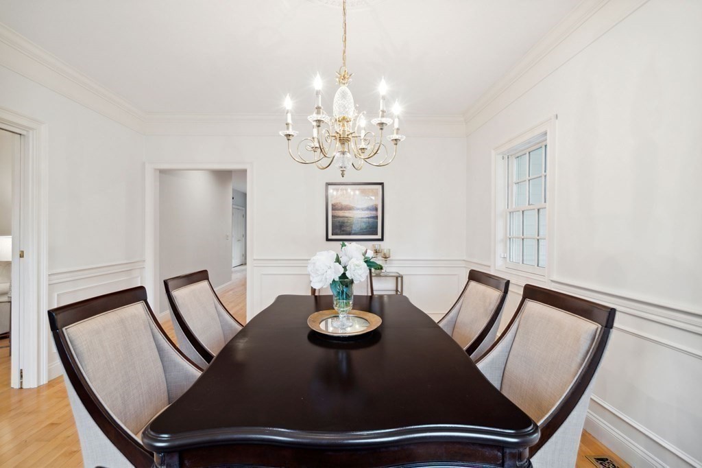 38 Pheasant Lane Manchester, NH 03109 - Photo 12 of 42 a view of a dining room with furniture a chandelier and wooden floor