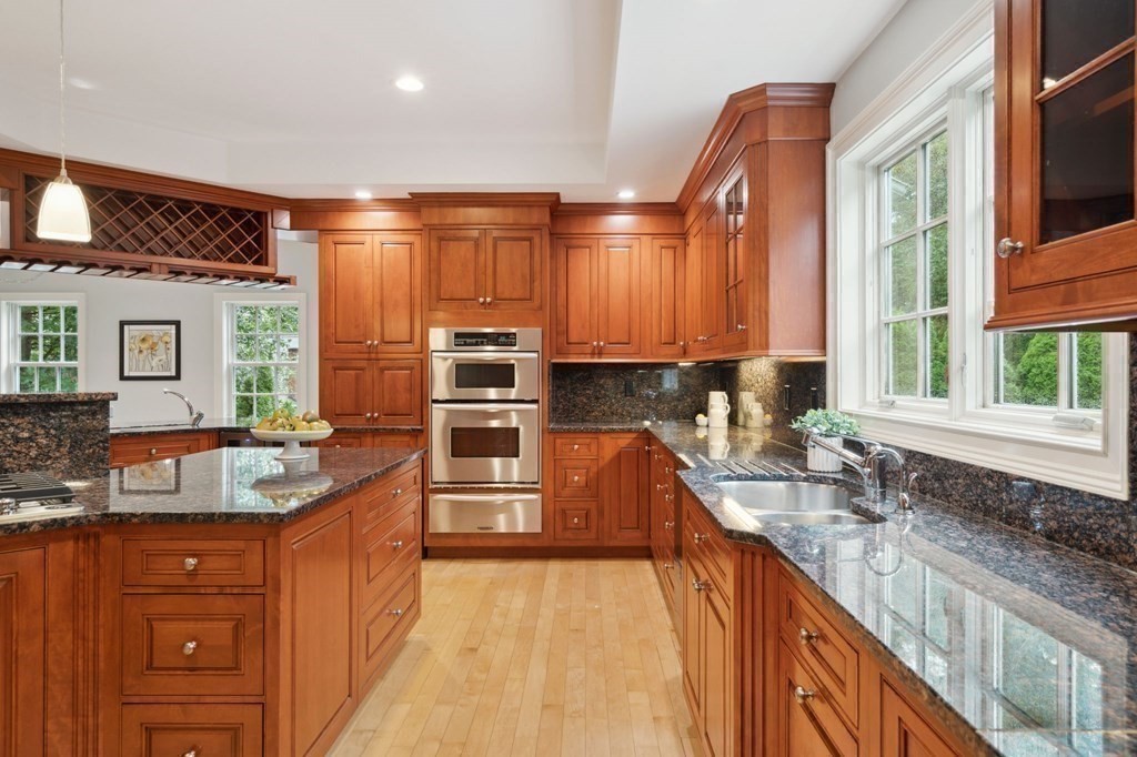 38 Pheasant Lane Manchester, NH 03109 - Photo 14 of 42 a kitchen with stainless steel appliances granite countertop a sink stove and cabinets
