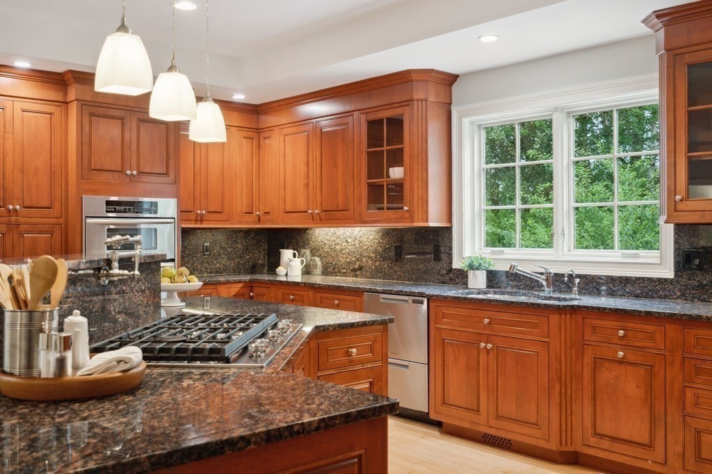 38 Pheasant Lane Manchester, NH 03109 - Photo 15 of 42 a kitchen with stainless steel appliances granite countertop a stove a sink and a granite counter tops