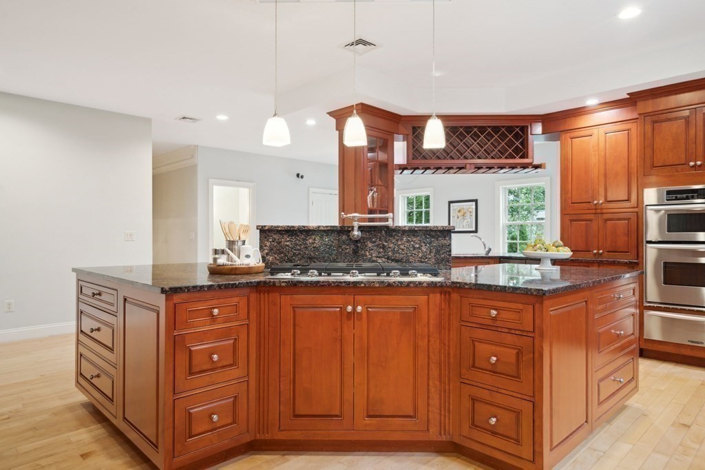38 Pheasant Lane Manchester, NH 03109 - Photo 16 of 42 a kitchen with granite countertop a stove and a sink