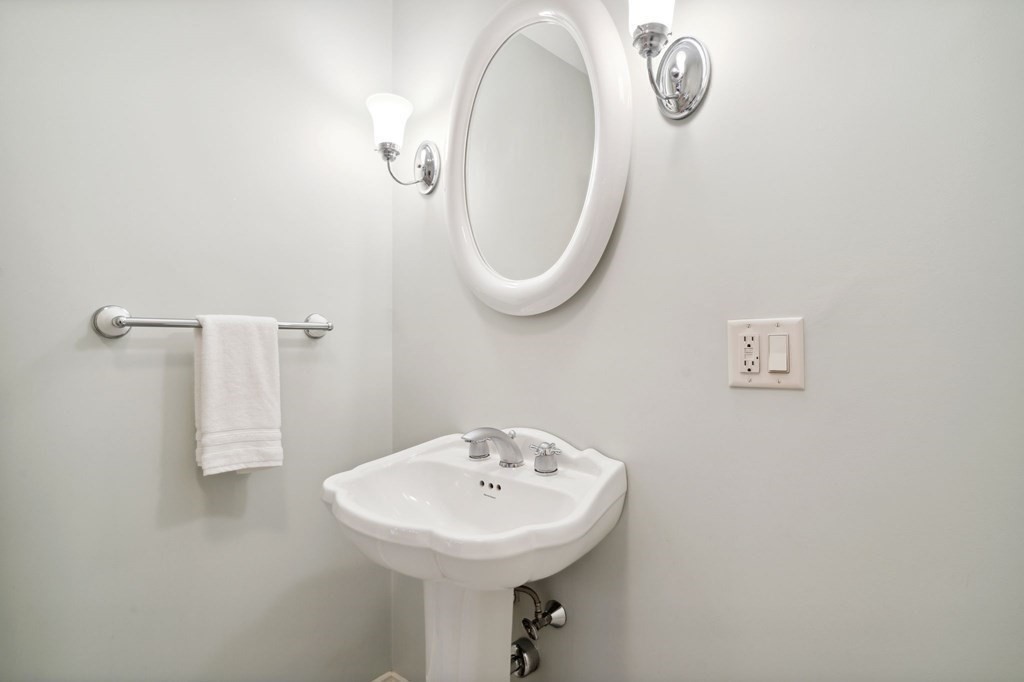 38 Pheasant Lane Manchester, NH 03109 - Photo 21 of 42 a bathroom with a sink a mirror and shower