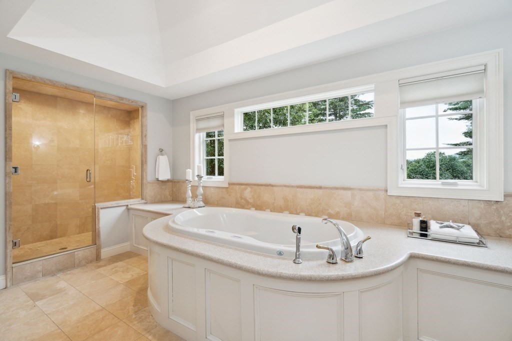 38 Pheasant Lane Manchester, NH 03109 - Photo 27 of 42 a bathroom with a bathtub and a sink