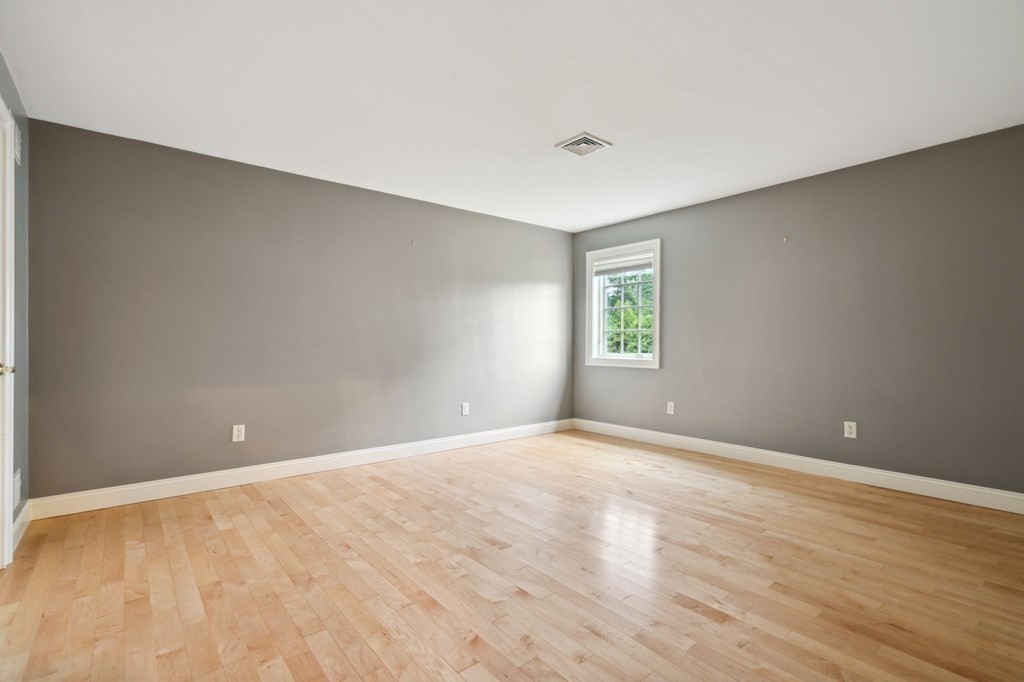 38 Pheasant Lane Manchester, NH 03109 - Photo 28 of 42 a view of an empty room with wooden floor and a window