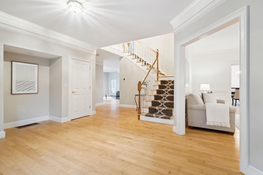 38 Pheasant Lane Manchester, NH 03109 - Photo 6 of 42 a view of a livingroom with wooden floor and stairs
